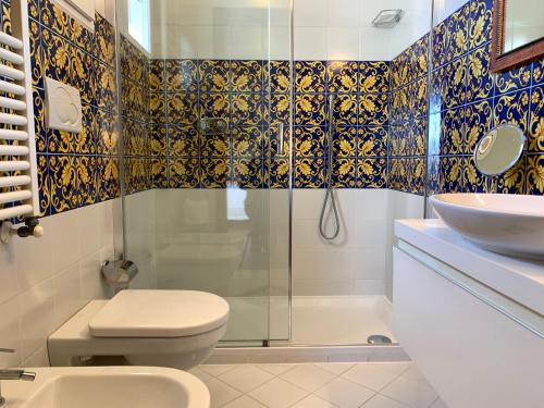 a bathroom with a shower and a toilet and a sink at Hotel David in Florence