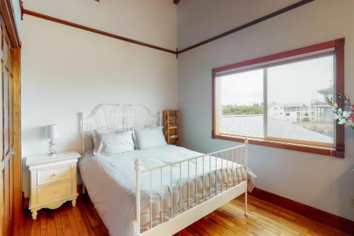 a bedroom with a white bed and a window at Expansive Views Family Oceanfront Beach Home in Westport