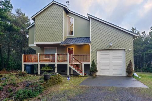 a house with a porch and a garage at Sand Castle Beach Home in Westport