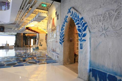 a hallway with blue and white walls and a tile floor at Mangrove Tree Resort World Sanya Bay-Kapok in Sanya