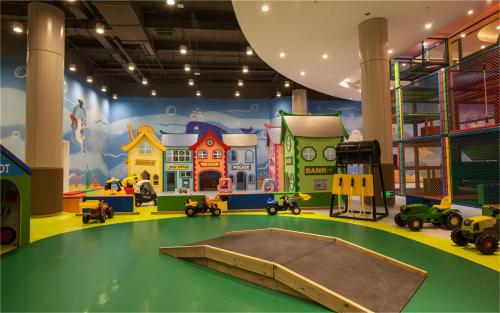 a play room with a trampoline in the middle of a play area at Mangrove Tree Resort World Sanya Bay-Kapok in Sanya