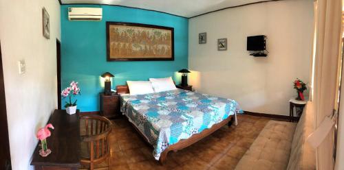 Ένα ή περισσότερα κρεβάτια σε δωμάτιο στο Mangga Bungalow