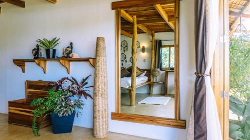 a mirror on a wall in a room at Sampaguita Villas in El Nido