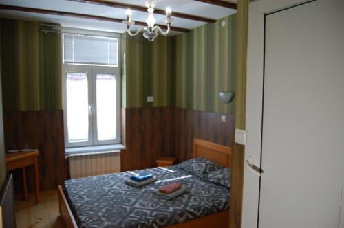 a small bedroom with a bed and a window at Stivan Iskar Hotel in Sofia