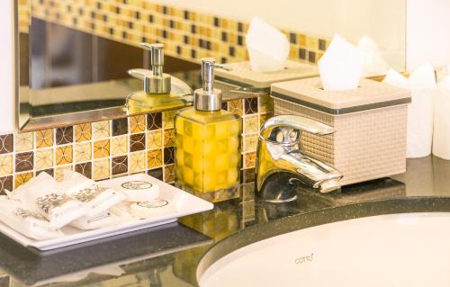 a bathroom counter with two bottles of soap and a sink at Krabi Phetpailin Hotel in Krabi
