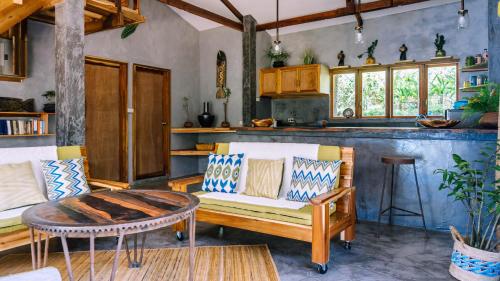 a living room with a couch and a table at Sampaguita Villas in El Nido