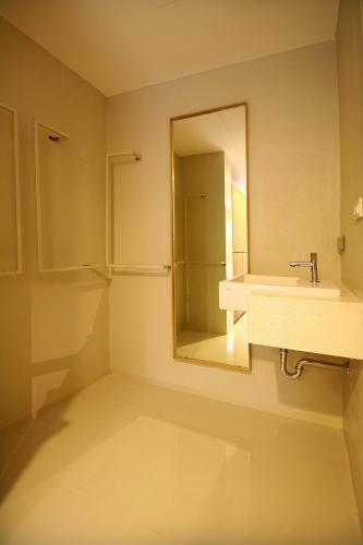 a bathroom with a sink and a mirror at CHERN Bangkok in Bangkok