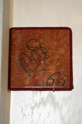 a brown wallet with a drawing of a woman at Albano Station Rooms in Pavona