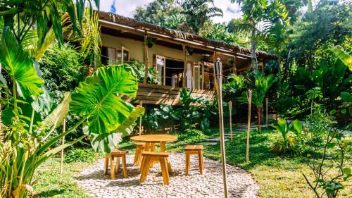 a house with a table and chairs in front of it at Sampaguita Villas in El Nido