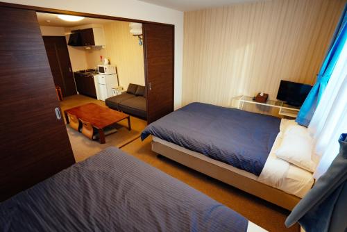 Ben's Guesthouse Kyoto tesisinde bir odada yatak veya yataklar