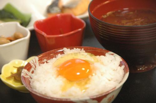 a bowl of rice with an egg on top at Onsen Yupopo in Senboku