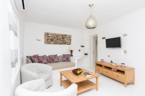 a living room with a couch and a table at Aegean White Home in Naxos Chora