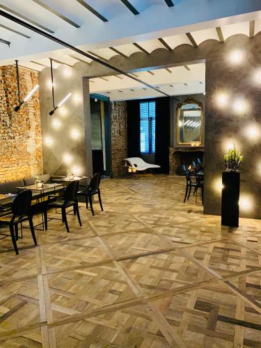 a lobby with tables and chairs and a piano at Landgoed Kasteel de Hoogenweerth in Maastricht