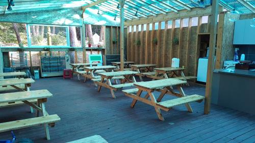 a group of wooden picnic tables in a building at White House in Sokcho