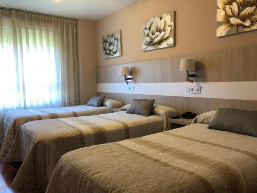 Säng eller sängar i ett rum på Hotel Bahia