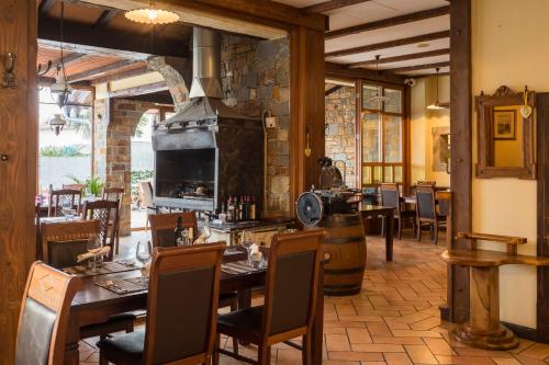 a restaurant with tables and chairs and a fireplace at Hotel Bio in Koper