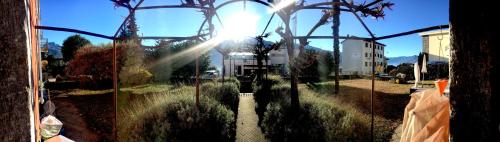 a view of the sun through a glass window at B&B villa sempreverde in Locarno