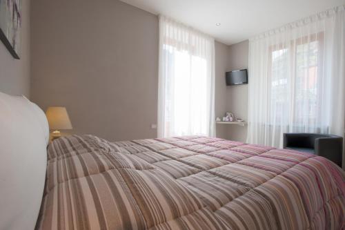 a bedroom with a large bed with a striped blanket at Affittacamere Da Paulin in Manarola