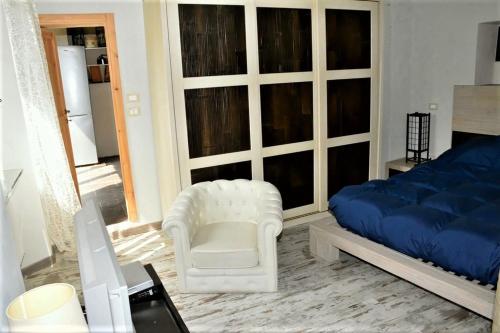 a bedroom with a bed and a chair and a couch at Villa Gioia in Acqui Terme