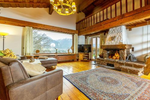 a living room with a couch and a fireplace at Salzburg-Chalet in Grossgmain