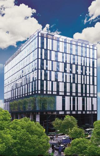 a large glass building with a lot of windows at Grand Central Hotel Shanghai - Nanjing Road in Shanghai