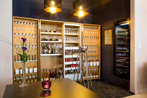 a wine tasting room with a table and wine bottles at Hotel Villa Vinum Cochem in Cochem