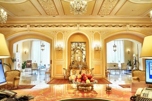 a lobby with a table with a bowl of fruit on it at Grand Hotel Continental Bucuresti in Bucharest