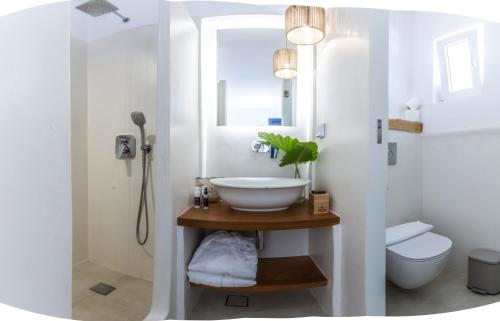 a bathroom with a sink and a toilet at Athina Studios and Suites Plaka in Plaka