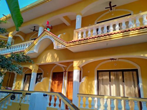 a house with a staircase in front of it at Primavera Holiday Homes-FAMILY RUN GOAN GUEST HOUSE in Candolim