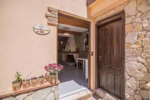 a entrance to a house with a door and flowers at B&B Issicoro in Baunei