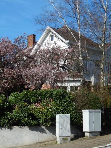 a white house with two electrical boxes in front of it at Les Remparts in Binche