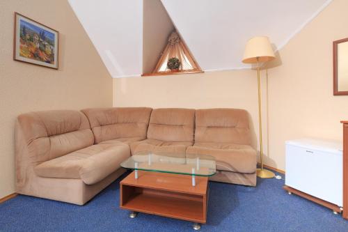 a living room with a couch and a table at Zhayvir in Kyiv