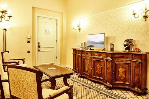 a room with a wooden cabinet with a television on it at Grand Hotel Continental Bucuresti in Bucharest