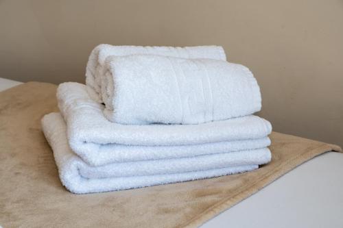 a stack of towels sitting on top of a bed at Olympic Coast in Olympic Beach