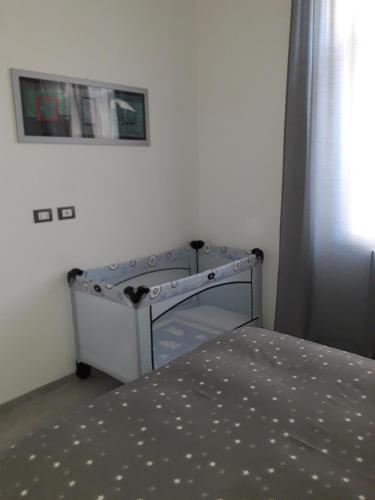 a bed in a bedroom with a bed frame and a window at La CasaLina in Omegna