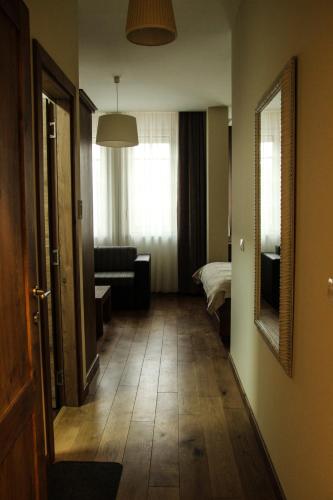 a hallway with a room with a bed and a mirror at B&B Villa Panuka in Pančevo