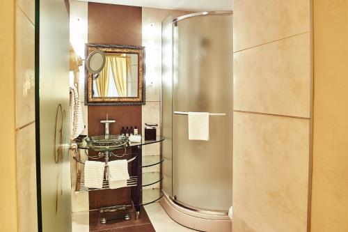 a bathroom with a shower and a sink at Grand Hotel Continental Bucuresti in Bucharest