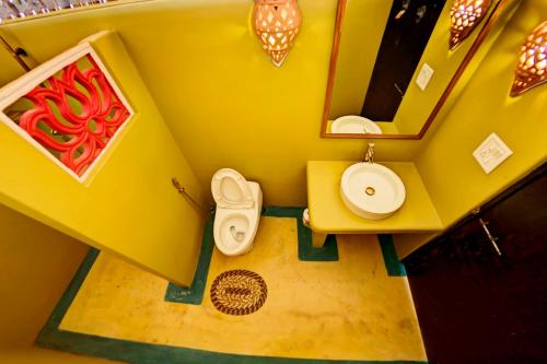 a model of a bathroom with a yellow wall at Beach Street Eco Resort - Mandrem in Mandrem