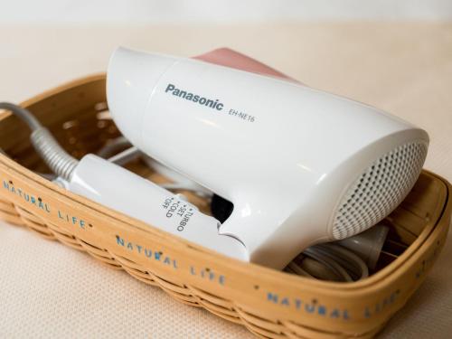 a hair dryer in a basket on a table at Super Hotel Takamatsu Kin en kan in Takamatsu