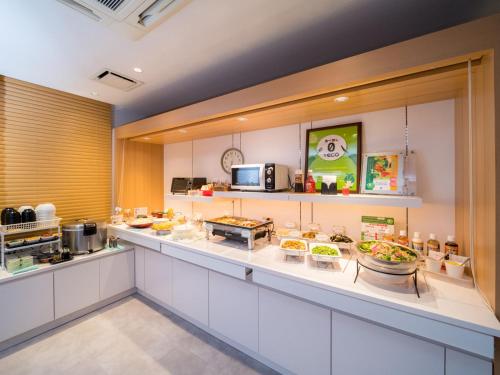 a kitchen with some food on a counter at Super Hotel Takamatsu Kin en kan in Takamatsu