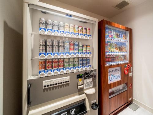 a refrigerator filled with lots of bottles of soda at Super Hotel Takamatsu Kin en kan in Takamatsu