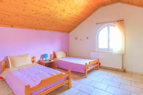 Postel nebo postele na pokoji v ubytování Villa Eftihia
