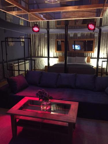 a living room with a couch and a table at WINE & ROSE BOUTIQUE HOTEL in Kharkiv