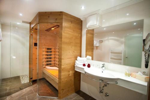 a bathroom with a sink and a shower at Brixnerhof im Zillertal in Schlitters