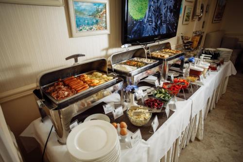 a buffet line with many different types of food at Optima Collection Zhytomyr in Zhytomyr