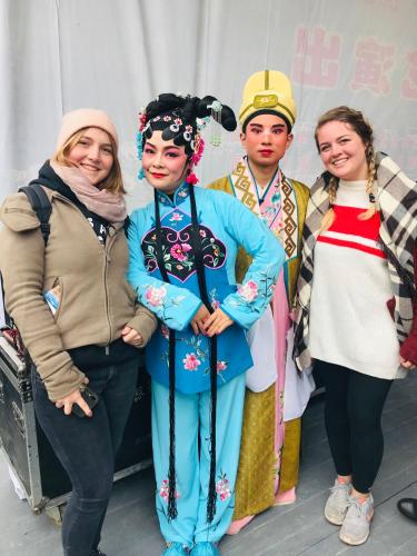 a group of people dressed in costumes posing for a picture at Tongfu Inn(In the National Park) in Zhangjiajie