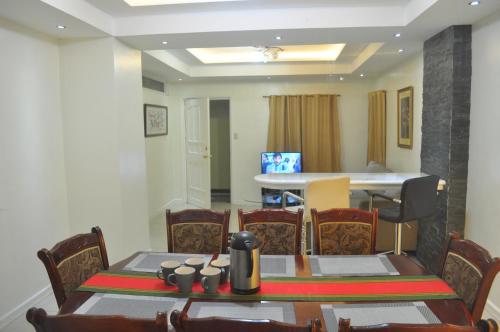 a dining room with a table and chairs at Golden Queen Suites in Baguio