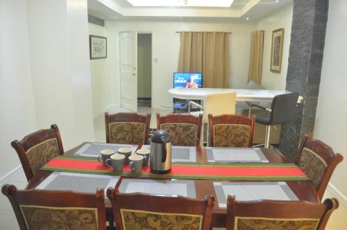 a dining room with a table and chairs at Golden Queen Suites in Baguio