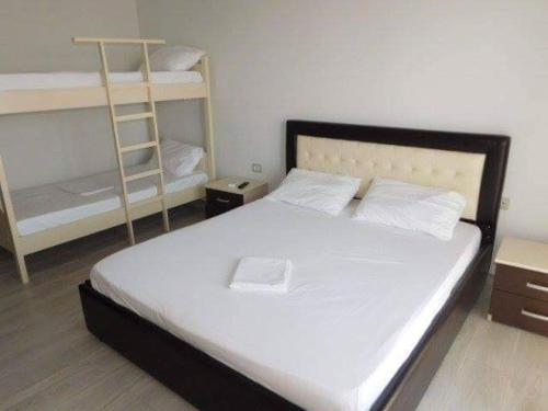 a bedroom with a bed and two bunk beds at Sea View Hotel Dhermi in Dhërmi