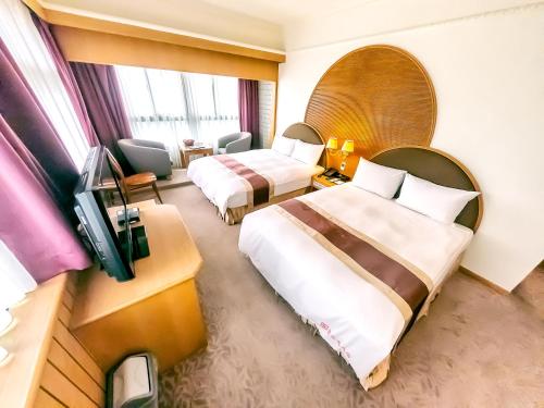 Foung Jia Hotel tesisinde bir odada yatak veya yataklar